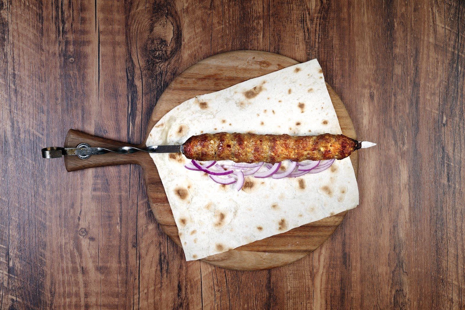 Kebab on lavash with onions